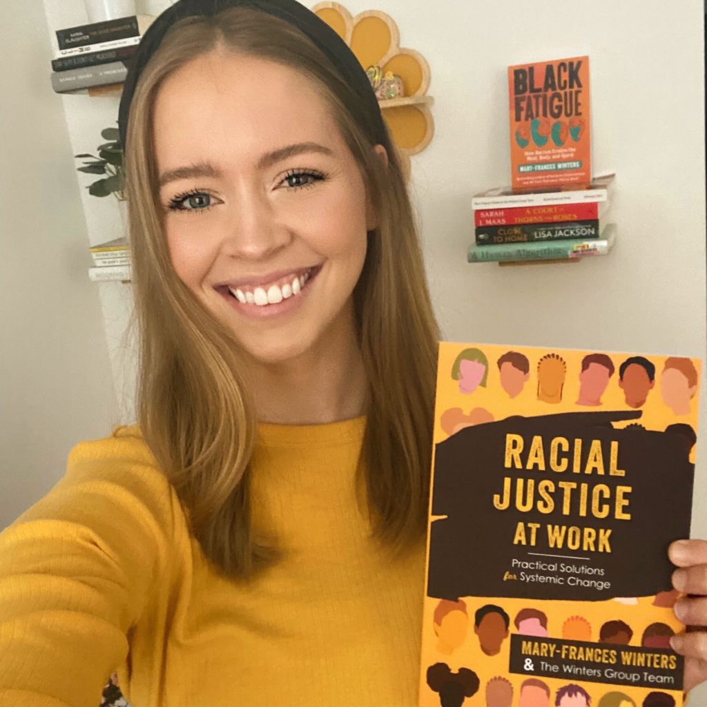 Megan Ellinghausen with a copy of Racial Justice at Work