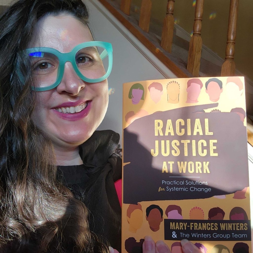 Megan Larson with a copy of Racial Justice at Work