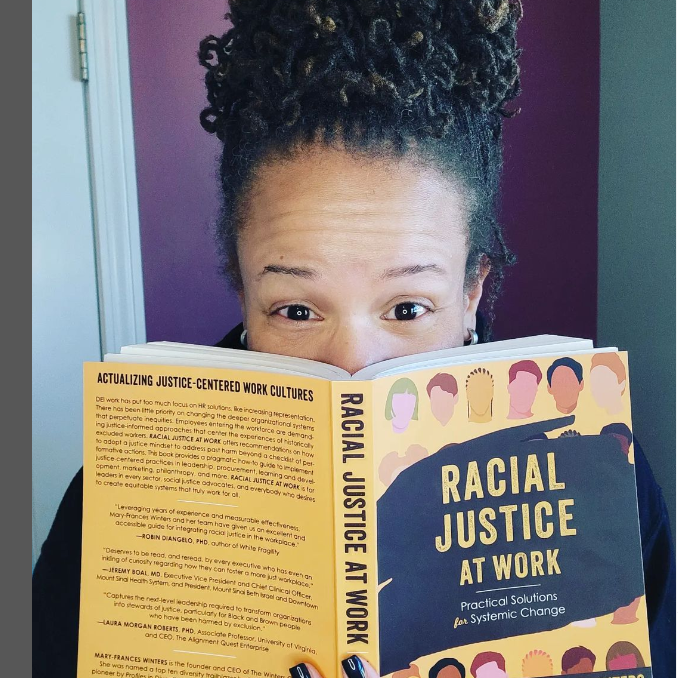 Mareisha N. Reese with a copy of Racial Justice at Work
